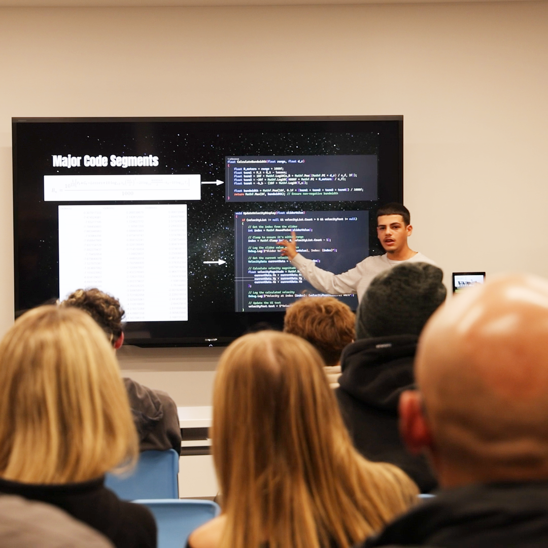 Kerellos walking through Artemis II mission code during a lecture